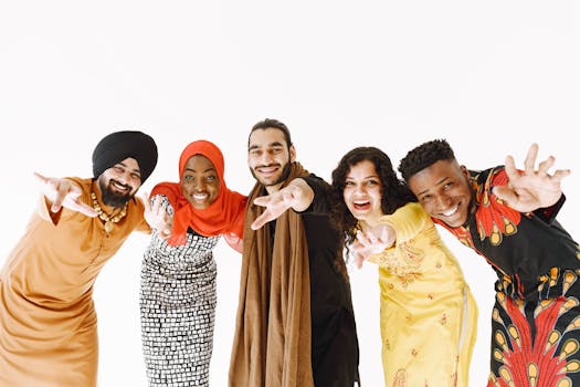 Diverse group of five friends smiling and celebrating together on a white background.